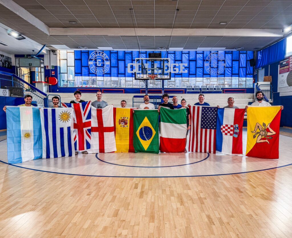 International basketball camp in Italy with Always Basketball coaches holding flags from around the world