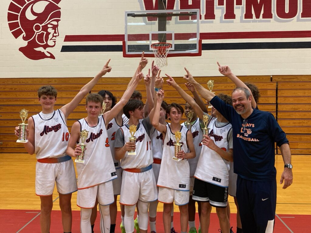 Always Basketball boys basketball team celebrating with trophies