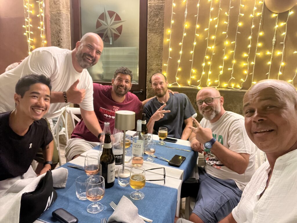 International basketball coaches sharing dinner together during an Always Basketball camp in Italy