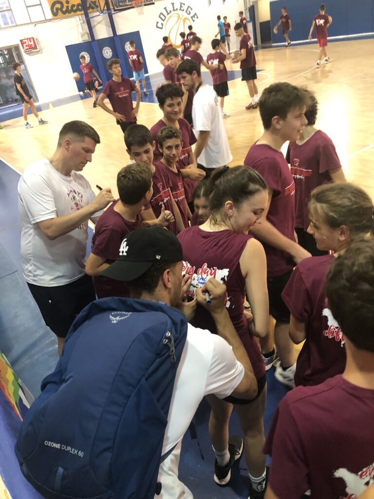 International coaches interacting with young players at an Always Basketball camp in Italy