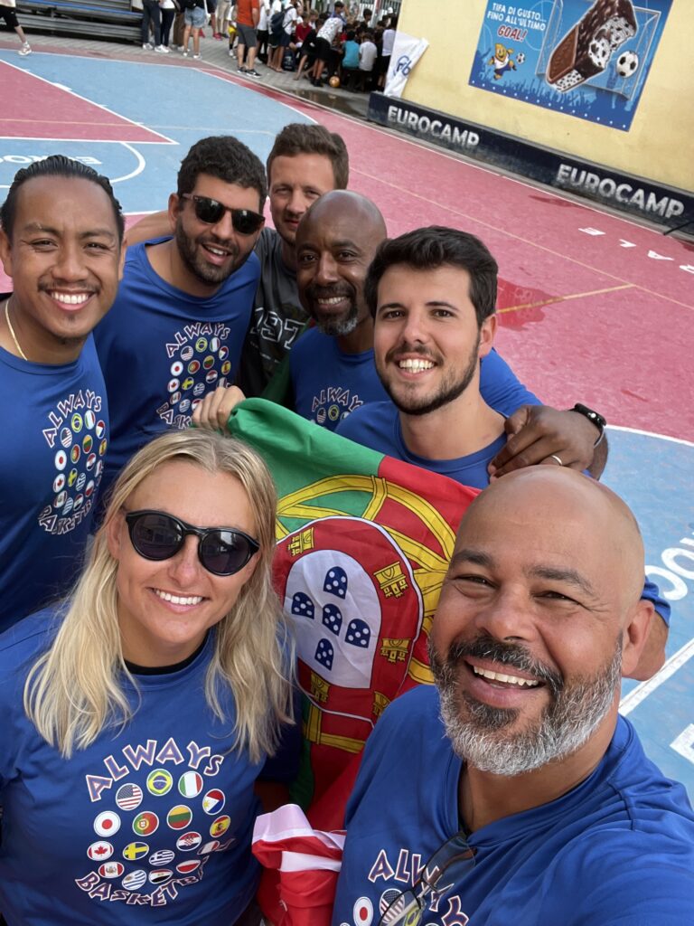 International basketball coaches at an Always Basketball camp in Italy with the Portugal flag